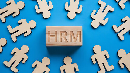 Obraz premium HRM: Human Resources Management, Employee Engagement, Recruitment, and Organizational Growth, human resources management concept. Wooden figures on the blue background, hrm copy space, hrm background