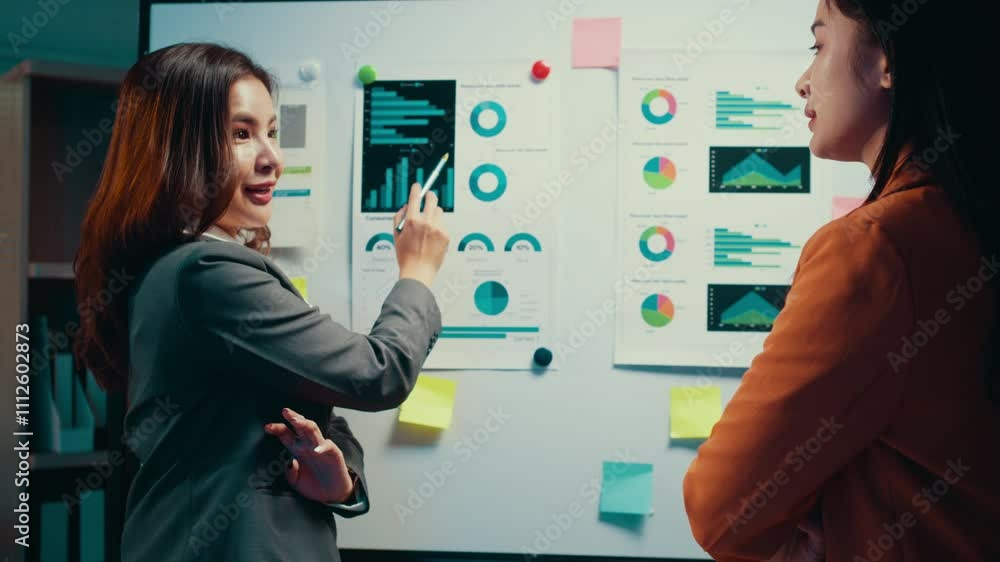 Aufkleber businesswoman pointing at a whiteboard filled with charts and graphs, explaining concepts to a colle
