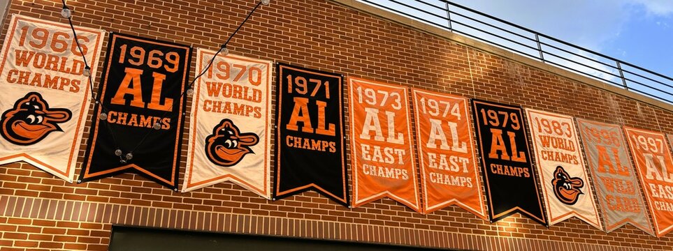 Baltimore, USA - September 15, 2024: Baltimore Orioles championship banners on exterior of Oriole Park at Camden Yards ballpark brick building facade in Baltimore, Maryland