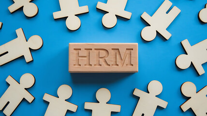 Obraz premium HRM: Human Resources Management, Employee Engagement, Recruitment, and Organizational Growth, human resources management concept. Wooden figures on the blue background, hrm copy space, hrm background