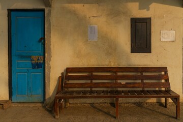 Rustic scene with bench and blue door