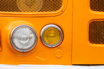 Close-Up of Vintage Vehicle Headlights and Grille horizontal