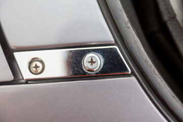 Screws on chrome grey detail of car