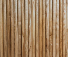 Volumetric wall with brown slats made of natural wood for interior. Aesthetics after renovation