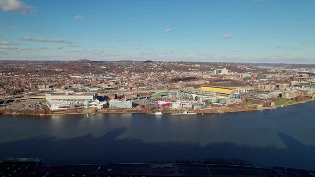 Pittsburgh, Pennsylvania  United States - November 27, 2024: Drone aerial of Steelers and Pirates sports stadiums named Acrisure and PNC Park field by Ohio river near downtown Pittsburgh