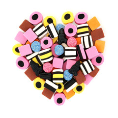 Licorice all sorts abstract heart shape design on white background. Old fashioned sweet food candy...