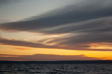 a sunset with clouds and a sunset on the horizon.
