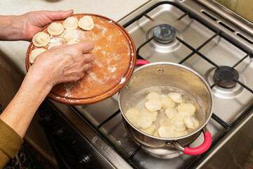 Cooking ravioli filled with minced meat in a steel pan.