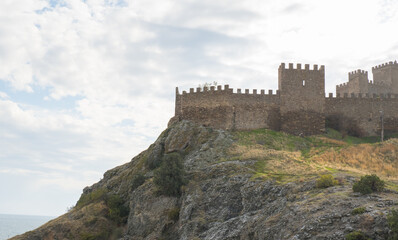 Old Genoese fortress in the city of Sudak in summer. Ancient architecture of Crimea.