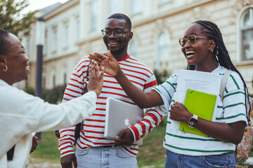College Students Sharing a Laugh and High Five on Campus