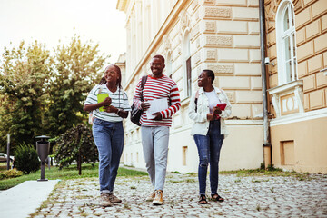 Group of Students Walking Happily Together Near University Building