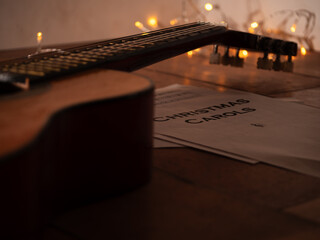 Acoustic guitar in front of Christmas lights 