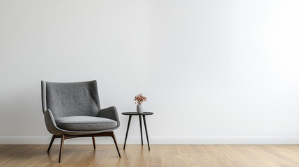Minimalist living room with a gray armchair and small table against a plain white wall. Modern interior design concept.