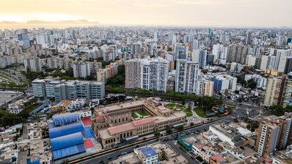 Fototapeta premium Drone view of a bustling south american cityscape full of buildings on a sunny summer afternoon