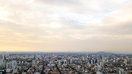 Obraz premium Drone perspective of a big city during a bright summer afternoon with a blue sky full of clouds