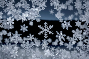 Snowflakes close-up. New Year card falling snowflakes on dark background close-up. New Year background of falling snowflakes.