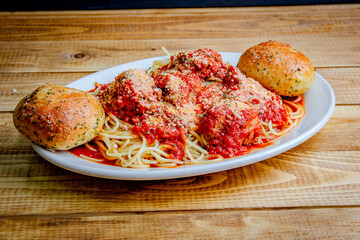 Spaghetti with tomato sauce and meatball in a white plate