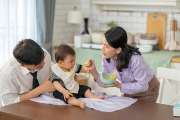 Asian baby and families who have to work while raising children at home