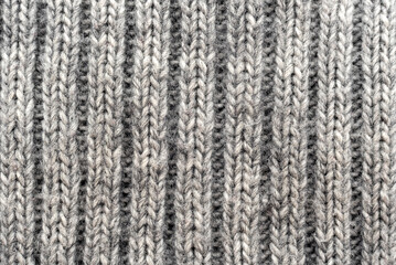 Texture of white or gray knitted material. Knitting