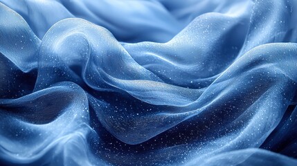 Obraz premium Flowing blue fabric with a delicate texture and sparkling details in soft lighting