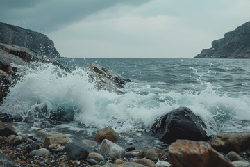 Ocean waves forcefully collide with rocky formations, showcasing the raw power of nature in a coastal setting. Crashing waves against a rocky seashore.