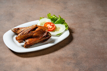 Bebek Goreng, Traditional Fried Duck. Popular Menu came from Madura, East Java. served with sambal, cucumber, tomato and lettuce.