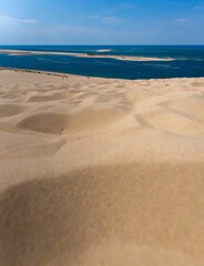 Scenic view of sandy dunes in a desert overlooking the sea in France