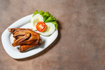 Bebek Goreng, Traditional Fried Duck. Popular Menu came from Madura, East Java. served with sambal, cucumber, tomato and lettuce.