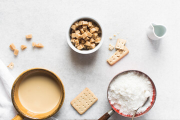 Overhead view of mise en place for making chocolate fudge with cookies and fudge pieces, Top view of ingredients of hazelnut chocolate fudge