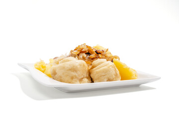 A plate of food with a white background. The food is a mix of potato and meat