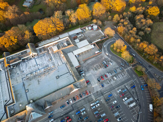 Aerial view of the popular seaside theme park seen on a sunny late autumn evening. Seen surrounded by golden trees.