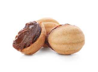 Sweet walnut shaped cookies with boiled condensed milk on white background