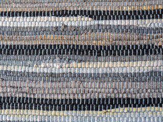 Hand woven rag rug background. Woven floor mat texture. Striped handmade doormat. Artisan fair....