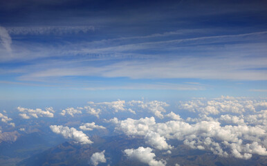 view from the window of an airliner with white clouds below