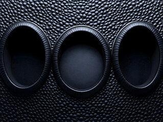 Three dark oval recesses in textured background.