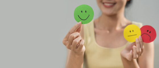 Customer satisfaction concept. Hand of a woman chooses a smiling face. Customer services best excellent business rating experience. Hand of client show a feedback with smiley face sign. Service rating