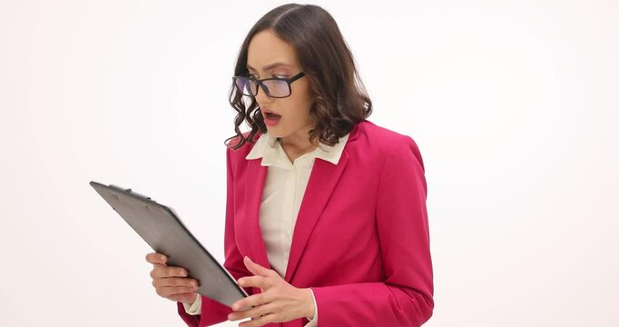 Businesswoman reads report and feels wave of shock on white background. Amazed female employee rereads shocking statistics and makes facepalm slow motion