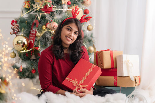 Happy young woman with Christmas gift