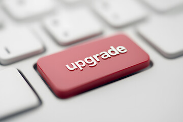 Close-up of a red button on a computer keyboard with the word ‘Upgrade’ printed on it, symbolising technology, progress, and the concept of improving or enhancing systems