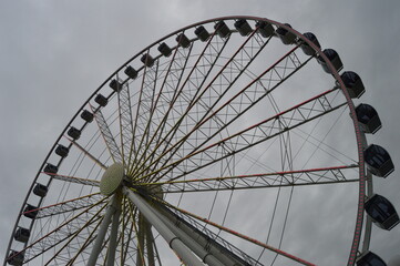 Ferris Wheel Against Dramatic Sky with Geometric Pattern