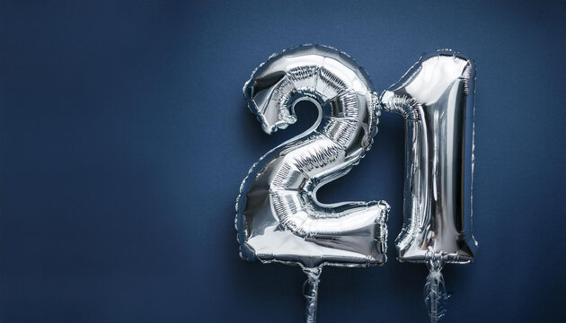 Banner with silver balloon in shape of number 21 against dark blue backdrop. Twenty one years