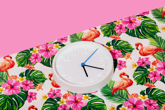 White clock with tropical fabric background and flamingo