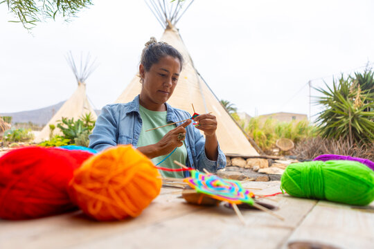 Woman Making Colorful Yarn Craft in Outdoor Setting