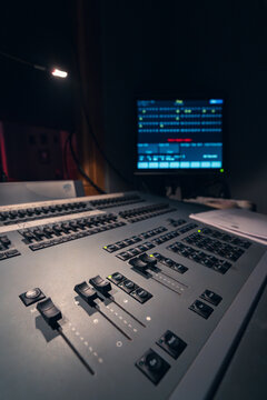 Professional audio mixing desk with illuminated controls