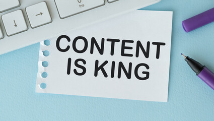 Fototapeta premium Paper written CONTENT IS KING on Blue desk with keyboard