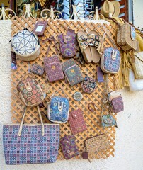 Display of handbags in a small market in an alley