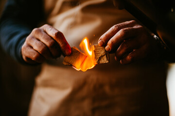 hands holding burning paper with flames, symbolic and artistic.