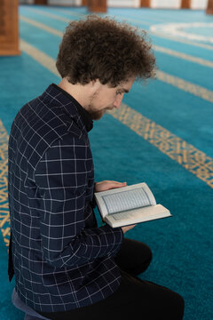 man holding and reading Quran
