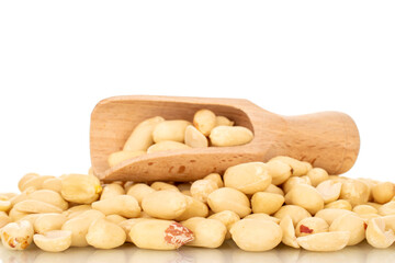 Roasted peanuts with wooden spoon, close-up, isolated on white background.