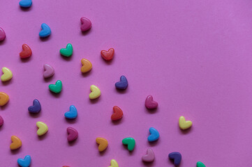 small multi colored hearts on pink background